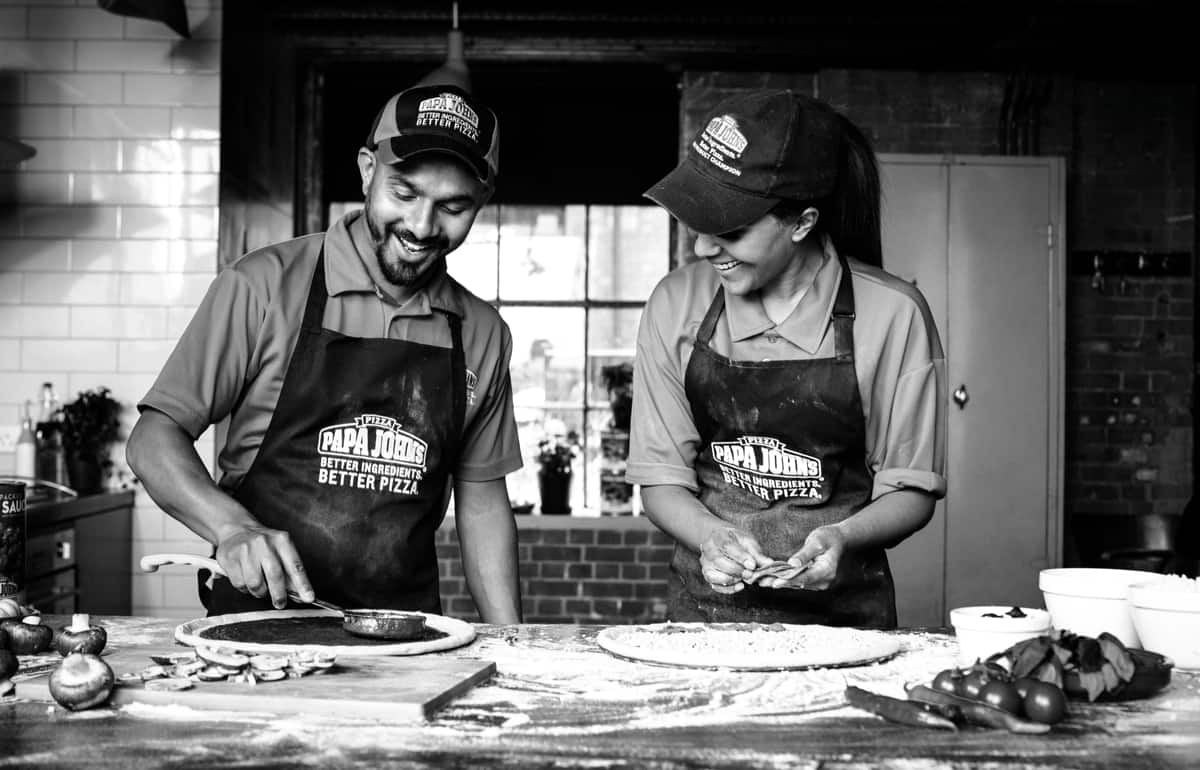 Team members making pizza