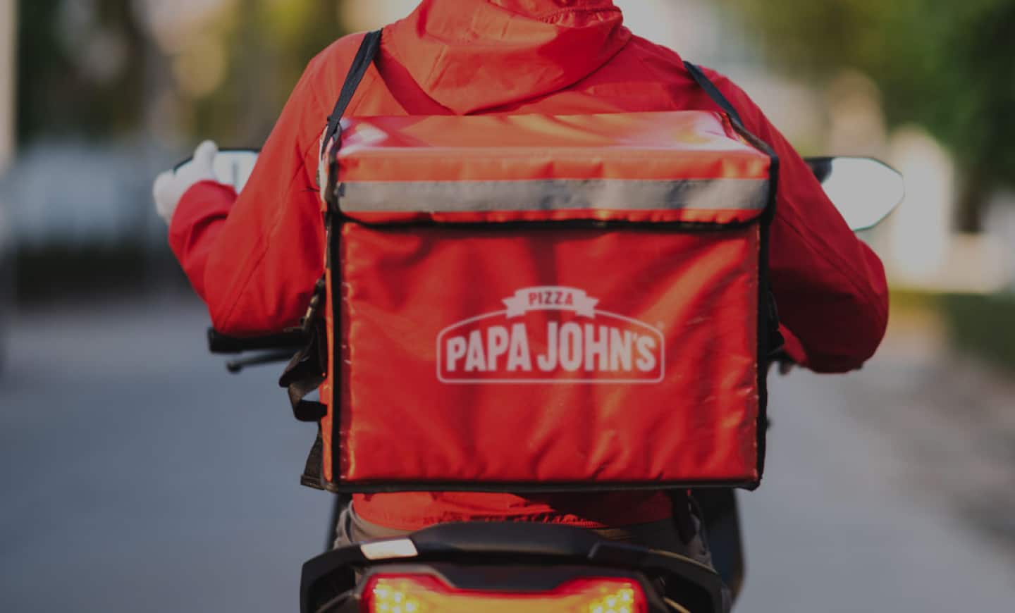 Papa Johns delivery driver carrying a pizza delivery bag